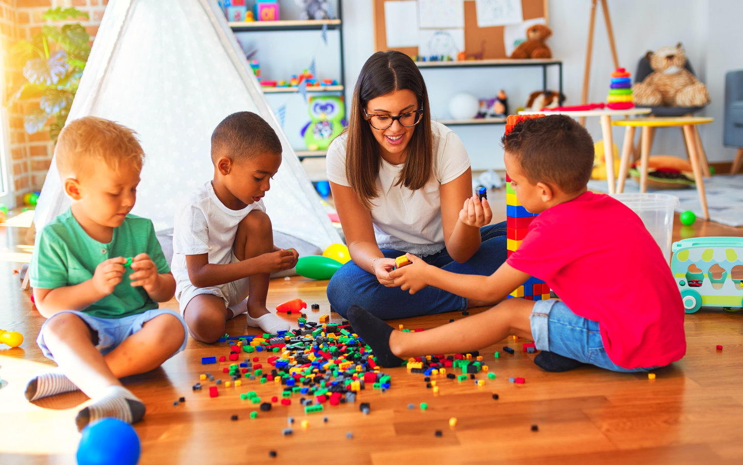 an adult woman playing with children
