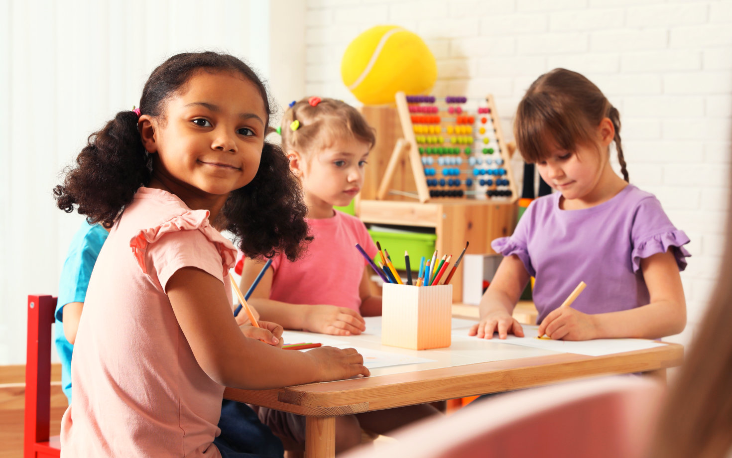 three children drawing